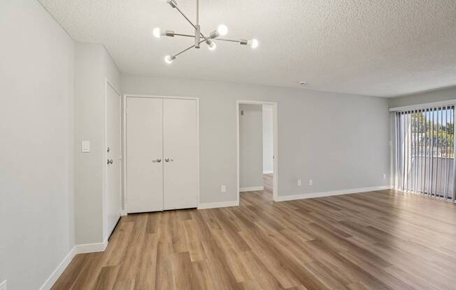 A room with a wooden floor and white walls.
