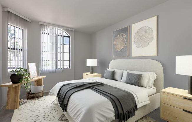 a bedroom with grey walls and a white bed