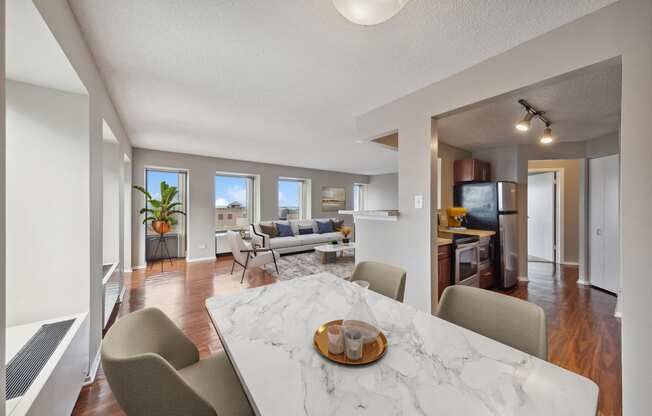 an open living room and dining room with a marble table and chairs