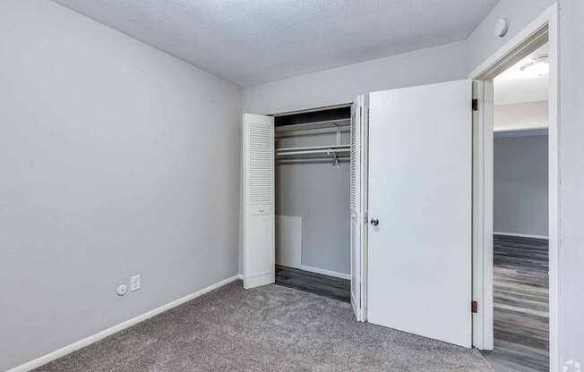 A white door is open in a room with a carpeted floor.