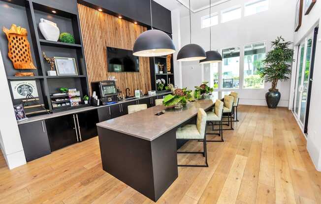 a large kitchen with a long counter and chairs