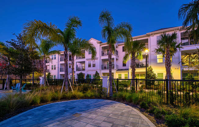 A building with a palm tree in front of it.
