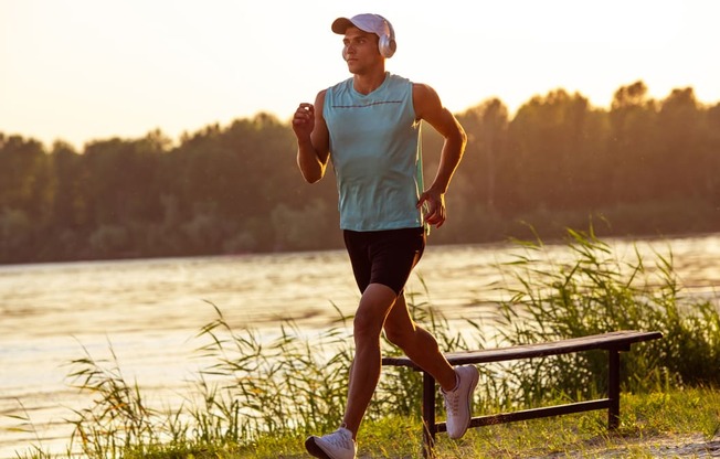 a man running next to a body of water