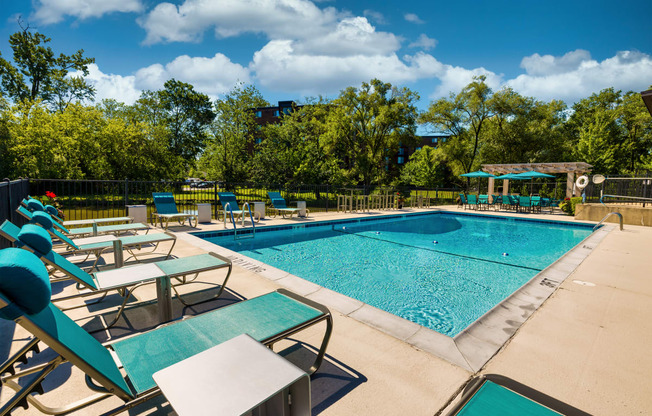 teal lounge chairs by an outdoor pool