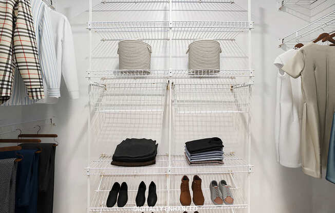 A walk in closet with wardrobe organizers at Colonial Pointe at Fairview Apartments, Bellevue, Nebraska