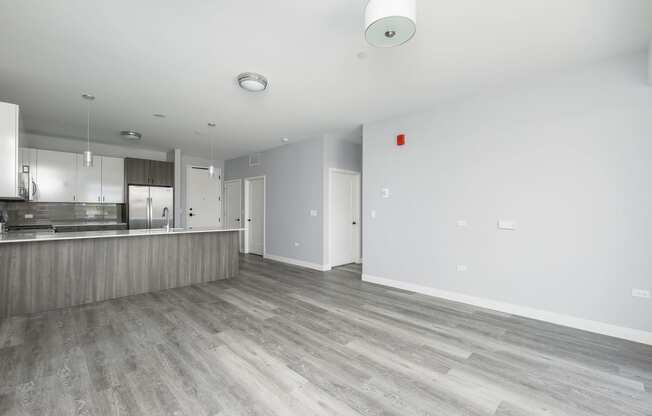 an empty living room and kitchen in a new home
