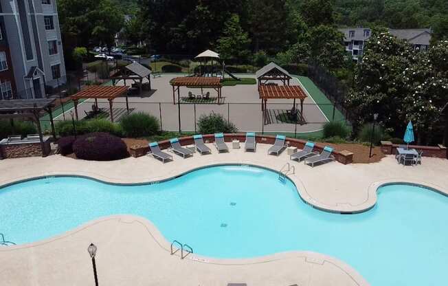 an aerial view of a swimming pool with chairs