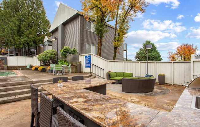 A patio area with a table and chairs in front of a building.