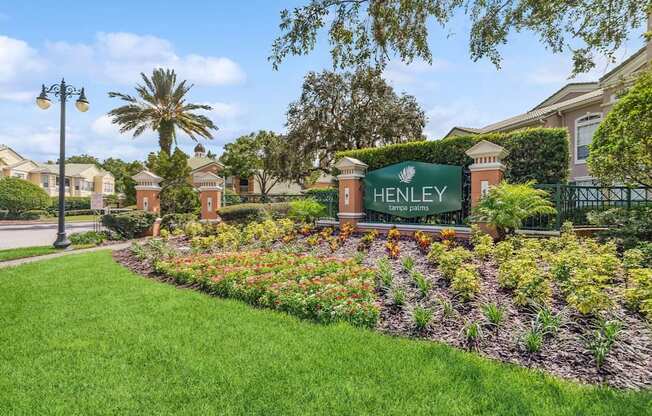the sign is in front of a garden with flowers, Henley Tampa Palms, Tampa, FL