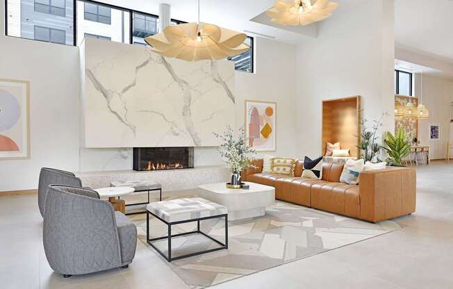 A modern living room with a fireplace and a grey armchair.