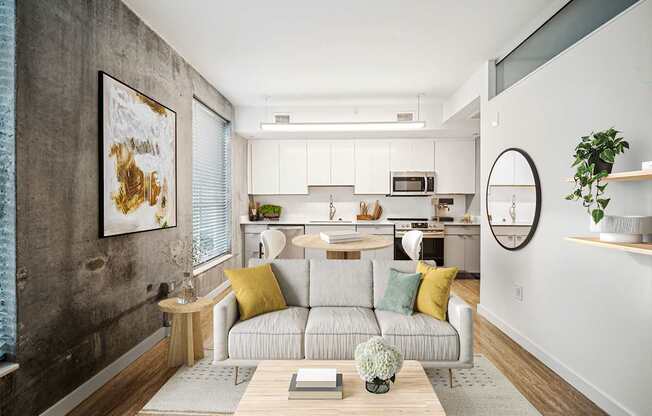 A modern living room with a grey couch and a coffee table.