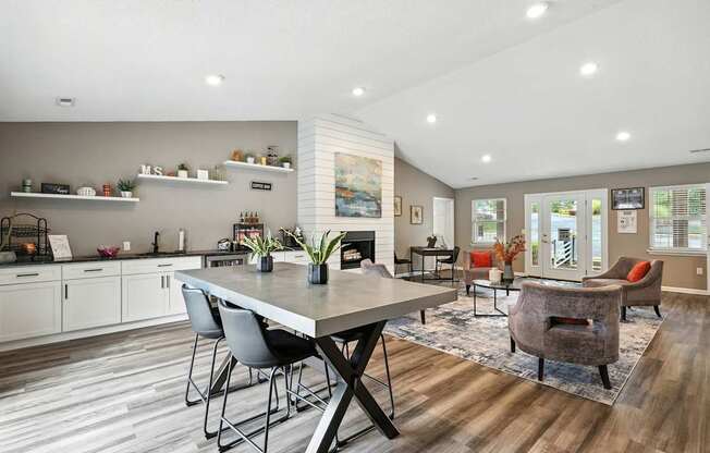 A modern kitchen with a dining table and chairs.
