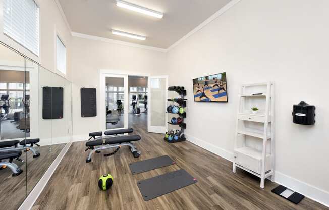 Premium fitness center with yoga room and free weights at at the Station at Savannah Quarters in Pooler, GA