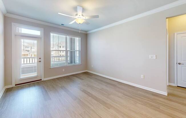 a living room with luxury vinyl flooring and ceiling fan