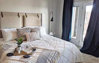 a bedroom with a bed and a window at GrandView Flats and Townhomes, Indiana