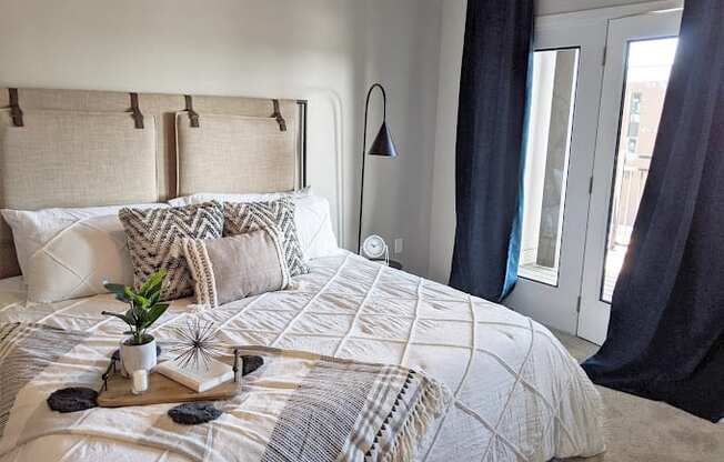 a bedroom with a bed and a window at GrandView Flats and Townhomes, Indiana