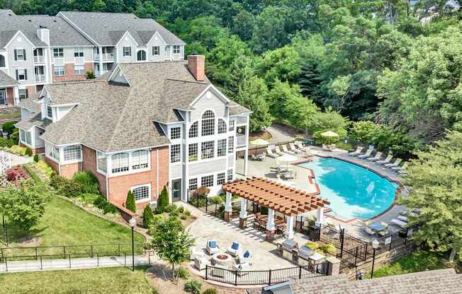 A large building with a pool in front of it.