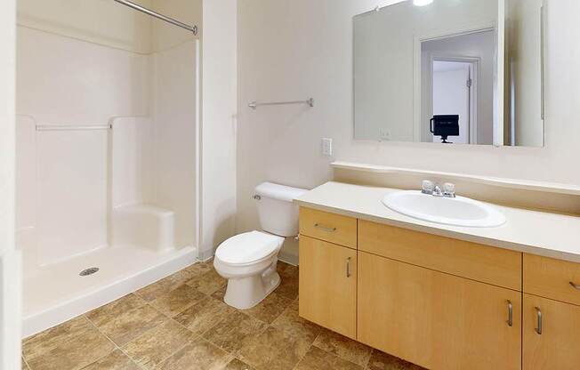 A toilet sits in a bathroom next to a sink and a shower at Foxwood and The Hermitage, Michigan