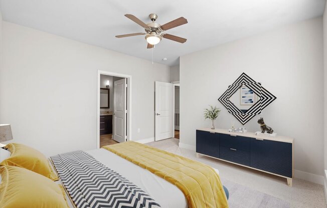 a bedroom with a bed and a ceiling fan