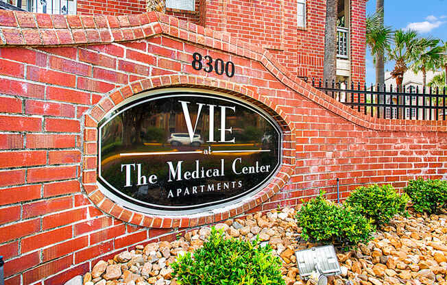 a brick wall with a sign for the medical center apartments