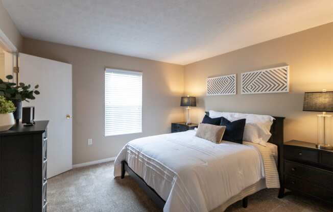This is a photo of the primary bedroom of the 890 square foot 2 bedroom, 2 bath Liberty at Washington Place Apartments in in Miamisburg, Ohio in Washington Township.