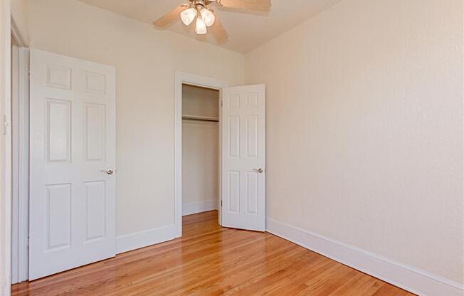 vacant bedroom with hardwood floors and ceiling fan at parkside apartments in washington dc