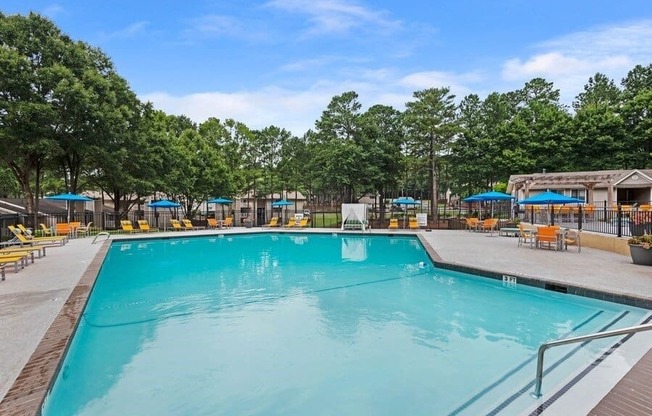 Swimming pool with cabanas and lounge chairs