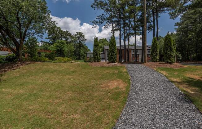 a view of a house from a gravel driveway