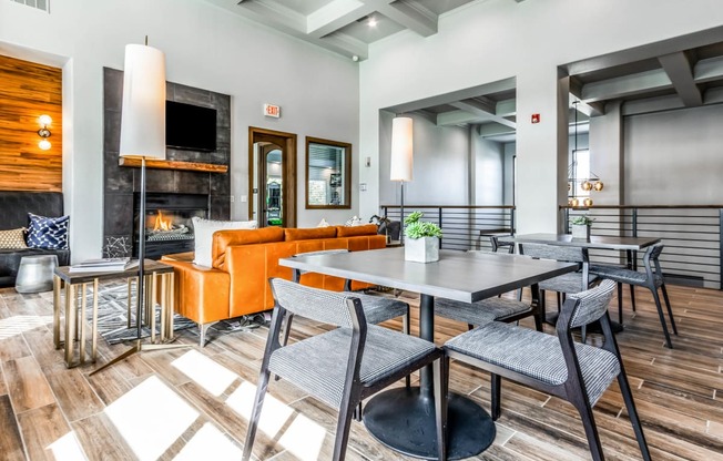 a living room with tables and chairs and a fireplace at The links at Plum Creek Apartments, Castlerock, 80104