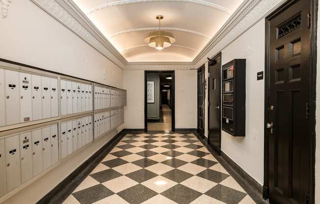 a long hallway with lockers and a checkered floor