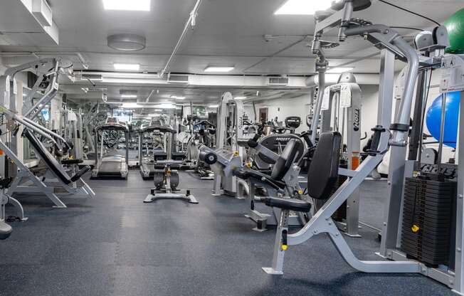 a gym full of exercise equipment in a building