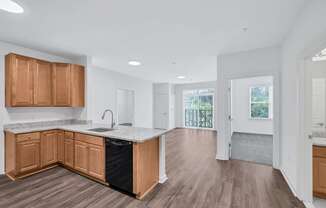 an empty kitchen with wooden cabinets and a counter top