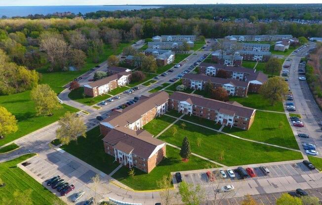 arial view of a neighborhood with green grass and trees