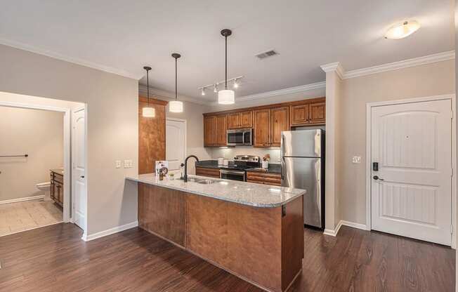 a kitchen with a large island and stainless steel appliances