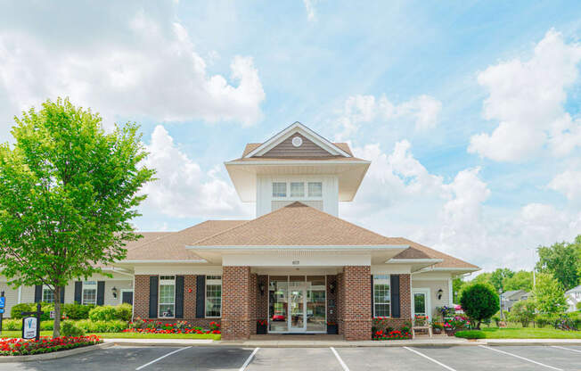 the exterior of a building with a parking lot and trees