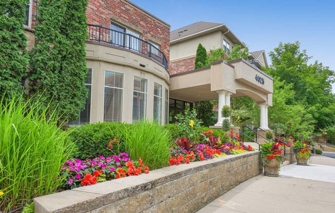 a house with flowers and plants in front of it