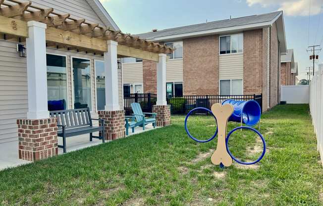 a yard with a pair of scissors in front of a building