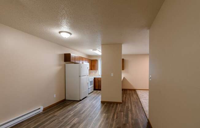 Grand Forks, ND Richfield Apartments. A dining room with a kitchen in the background.