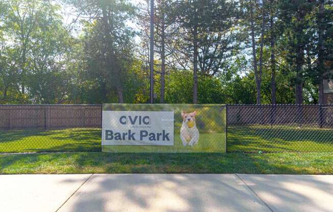 a sign for cvc bark park with a dog on it