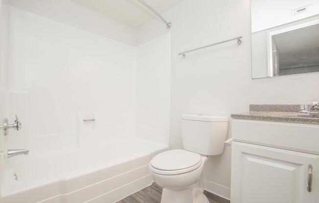 a white tub sitting next to a shower