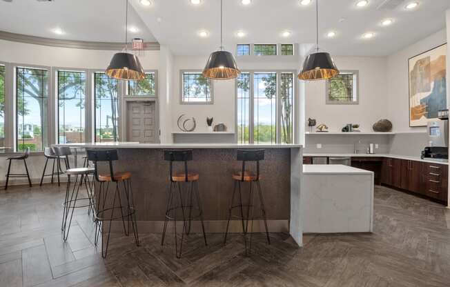 a kitchen with a marble counter top and bar stools at Mission Gate, Plano, Texas