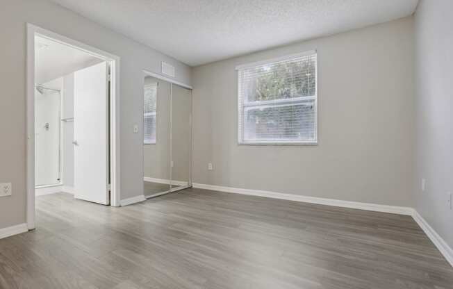 an empty living room with wood floors and a window at Pembroke Pines Landings, Florida