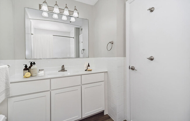 Model bathroom with a sink and a mirror at Stone Ends apartments in Stoughton, MA
