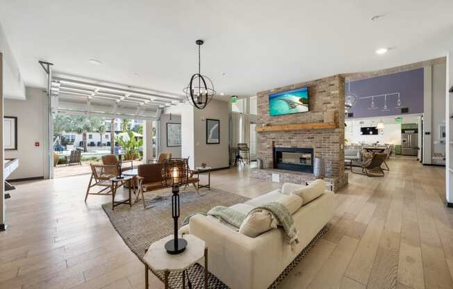 the living room has a large stone fireplace and hardwood floors