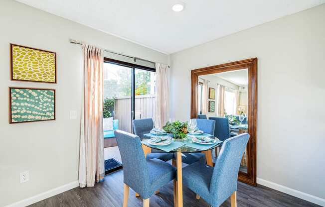 a dining room with a glass table and chairs