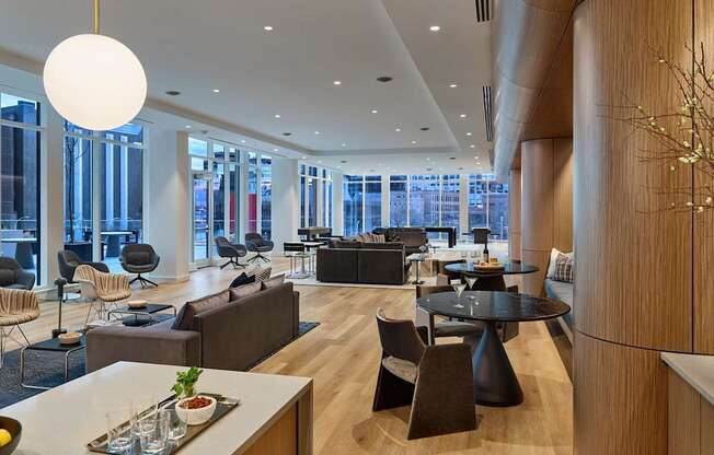 A modern living room with a large window and a dining table.