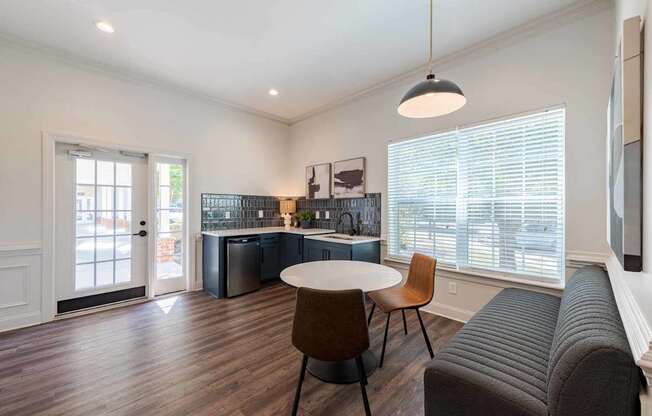 A modern living room with a grey sofa and a round table.