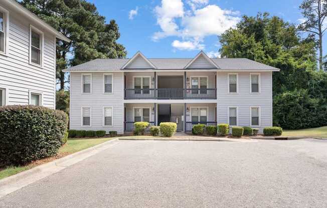 A two-story house with a balcony on the second floor.