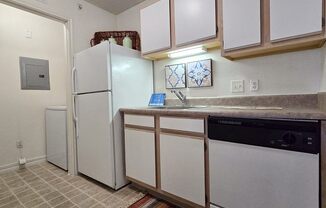 a kitchen with a refrigerator and a sink