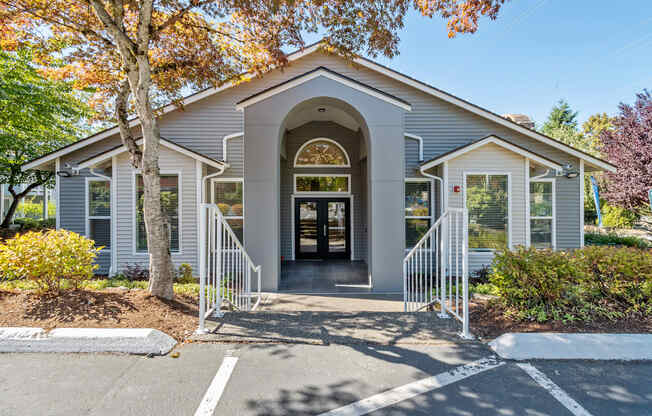the front of a church building with stairs and a door